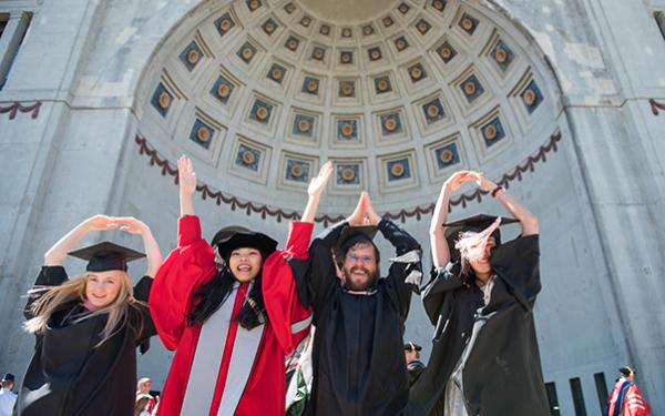Students in graduate clothing doing O-H-I-O